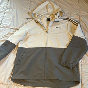 2-tone Adidas grey jacket. Slight staining in the mid abdomen area.